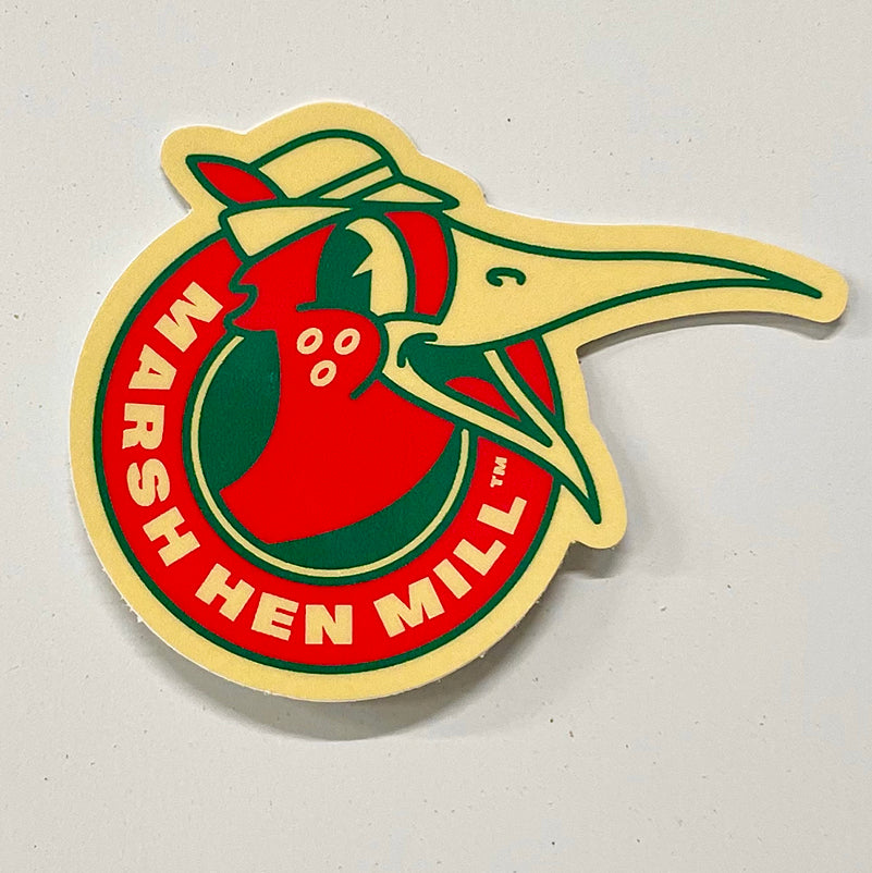 3 inch round decalof cartoon marshhen in red green and off white with "marsh hen mill" around the outside.